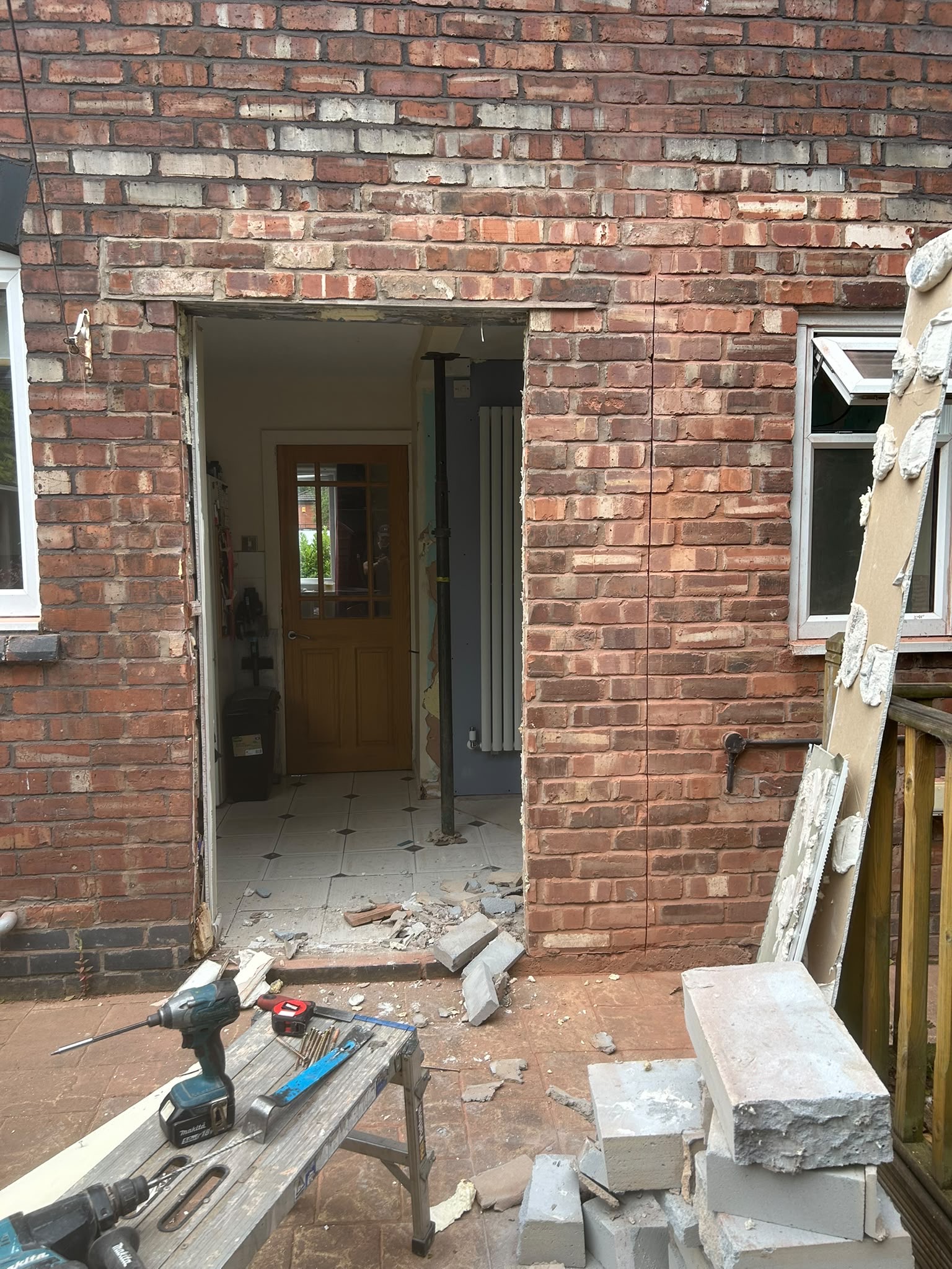 Brick wall opened up to create wider opening for French doors in Chorlton