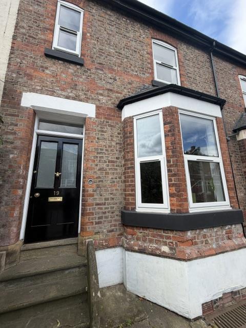 Period brick home in Urmston before replacement of white casement windows