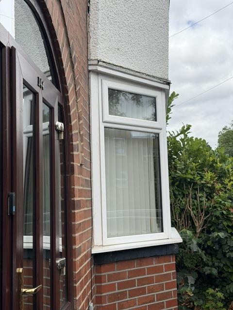 Side view of the original lower bay window and rendered middle section before work.