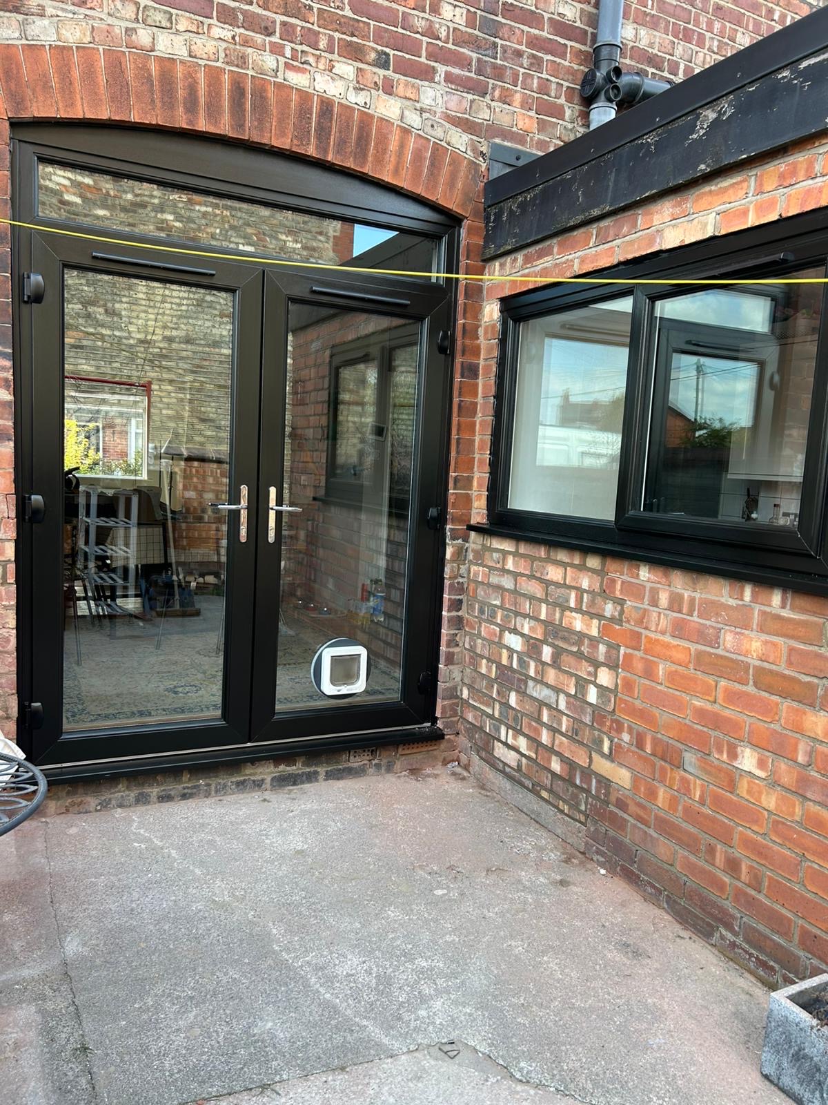 New black French doors and matching kitchen window in Stretford