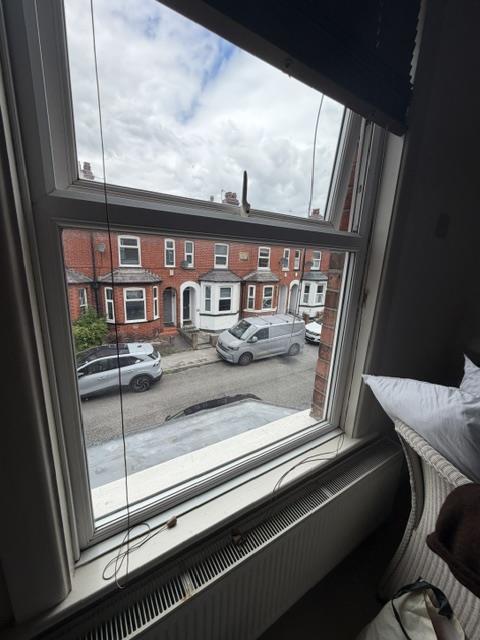 Interior view of white uPVC casement window before replacement with sliding sash