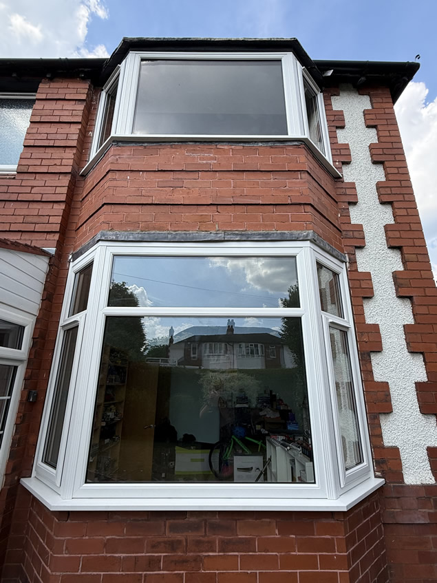Front bay in Altrincham with large white replacement windows and fewer glazing divisions