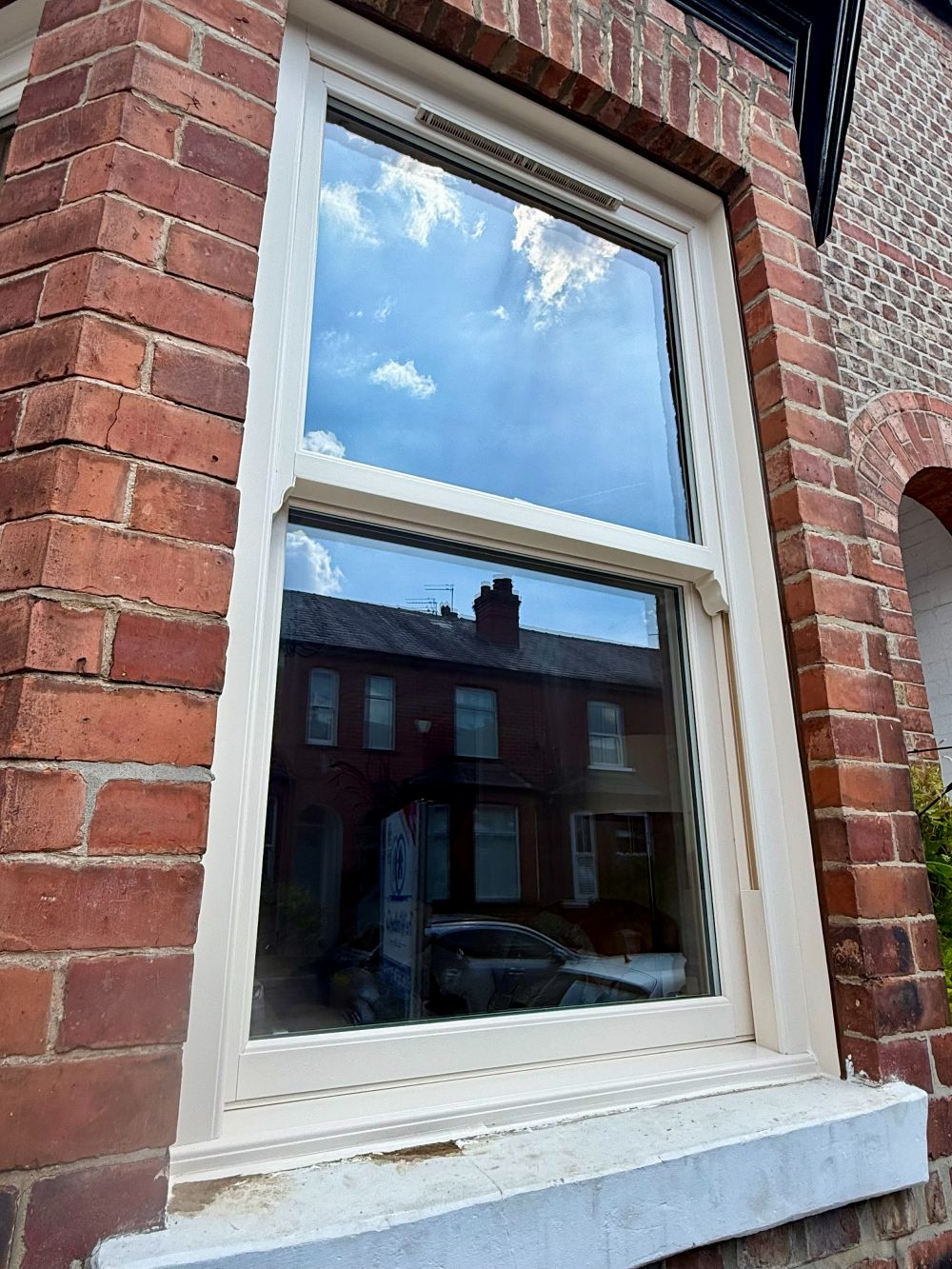 Cream uPVC sliding sash window installed in a period home in Altrincham