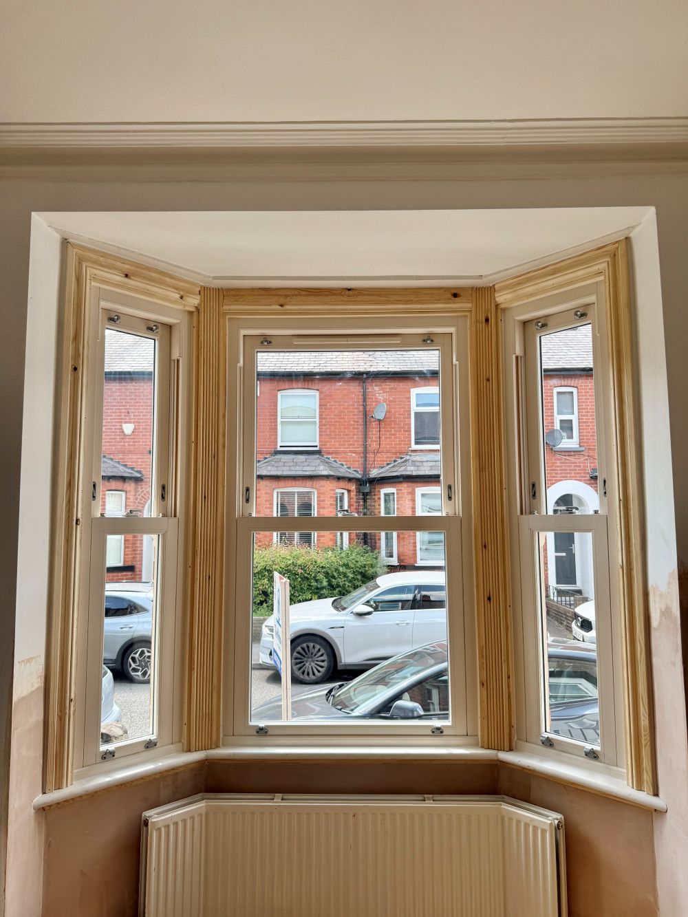 Internal Victorian bay with cream sliding sash windows and moulded timber architraves