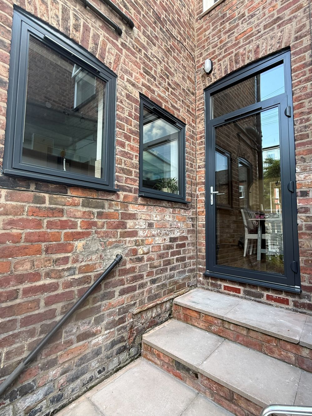 Grey aluminium windows and glazed rear door installed at an Altrincham home