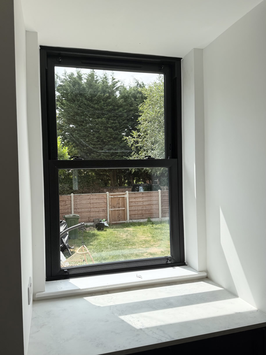 Interior view of dark sash window installed at rear of period home