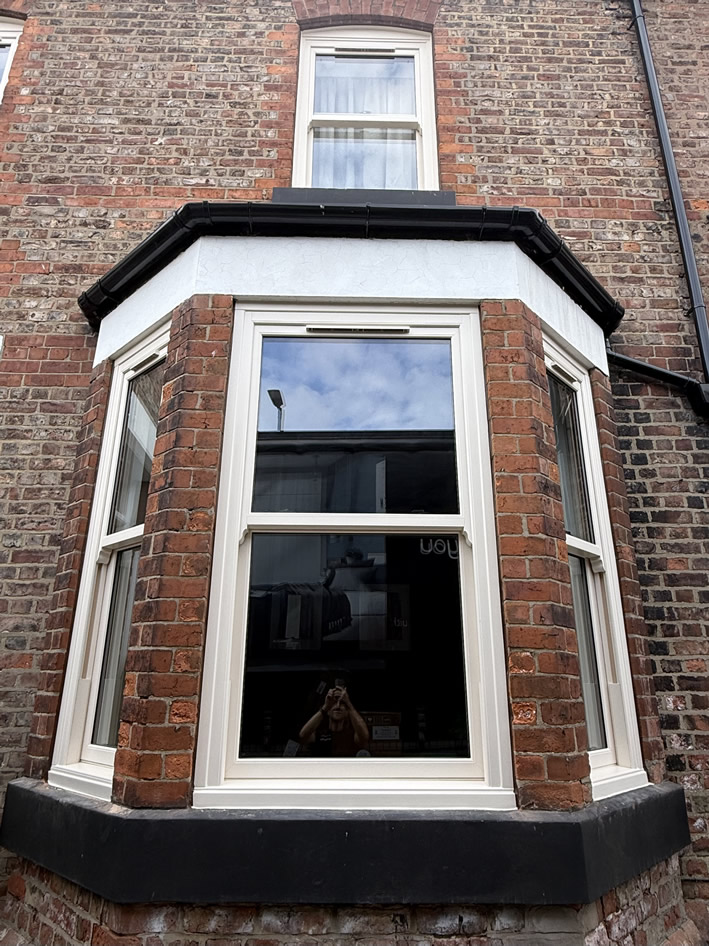 Front bay of Urmston period home after installation of cream sash windows
