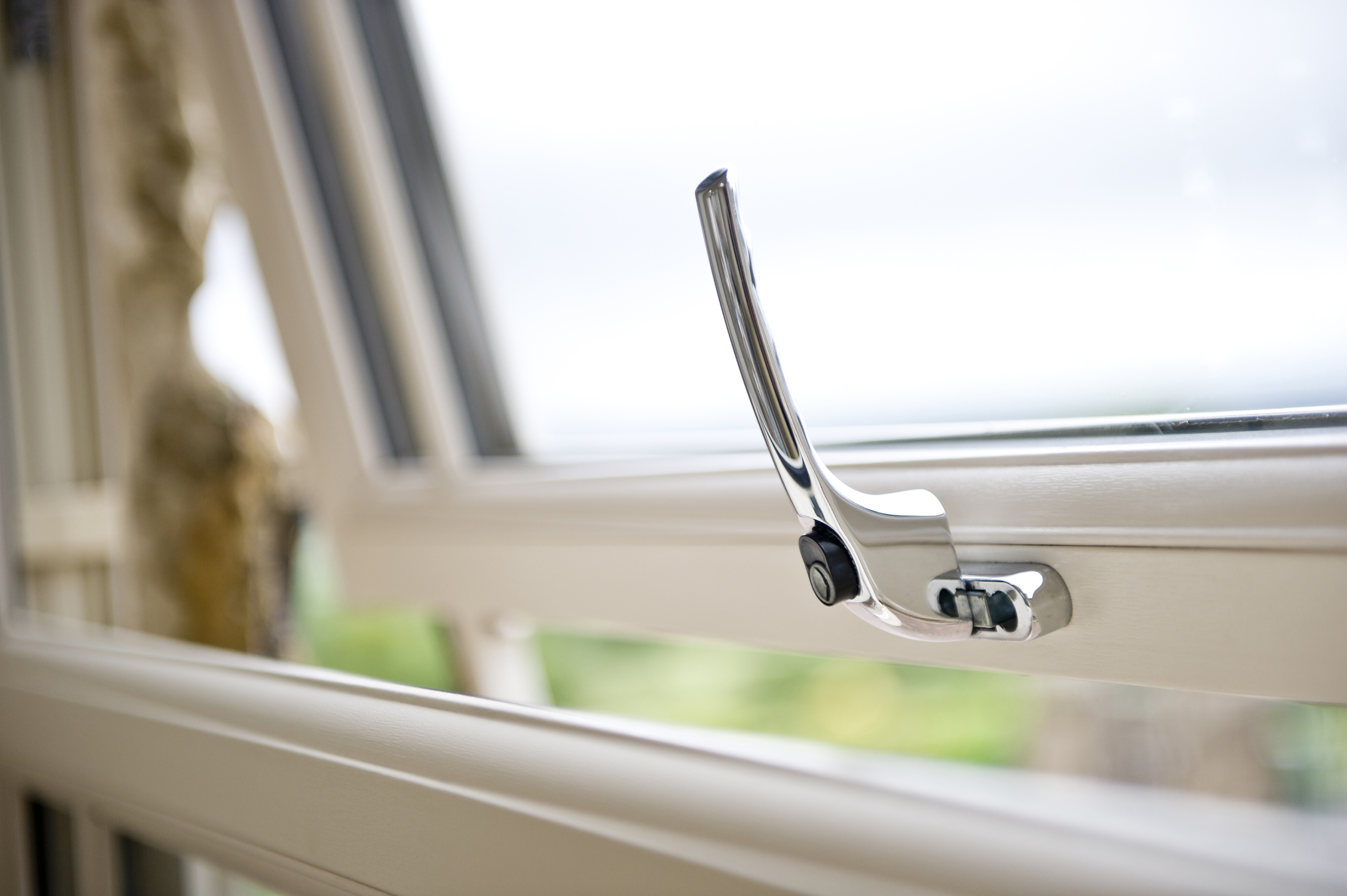 artistic photo focusing on open casement window handle - The Windows Co