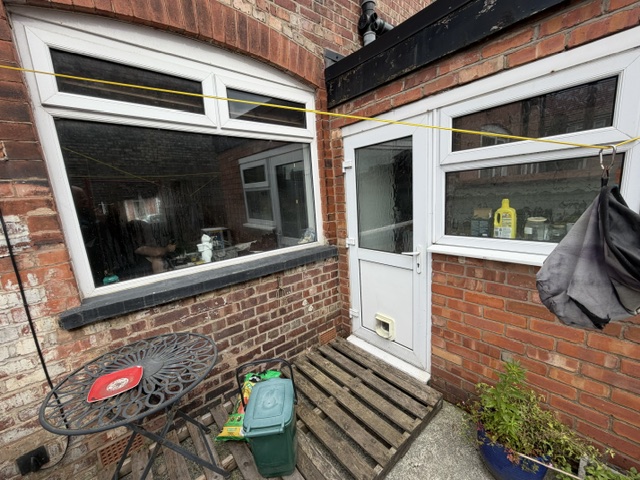Existing kitchen back door and window before alteration in Stretford