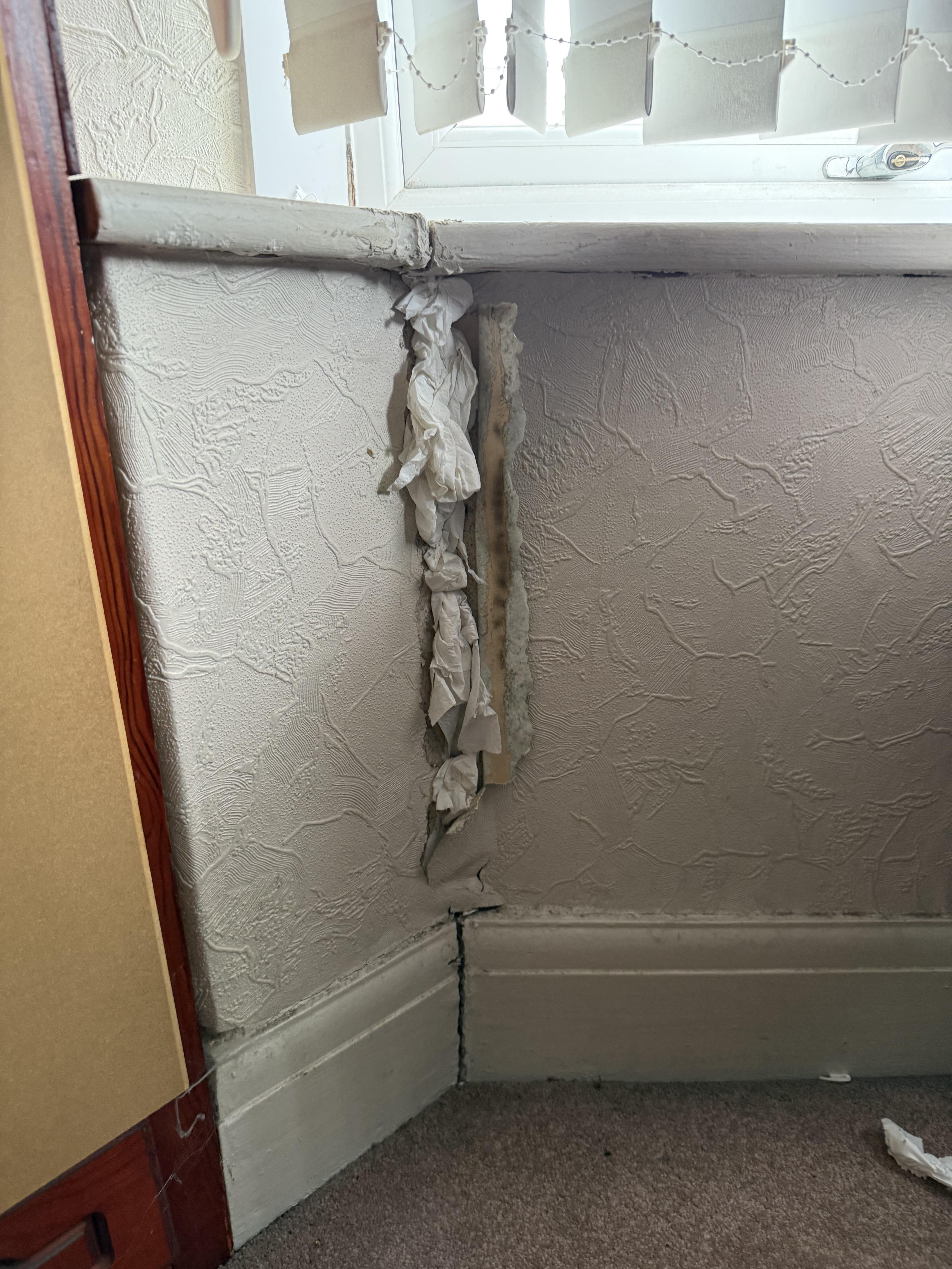 Gap in the internal wall finish beside the original bay window frame.