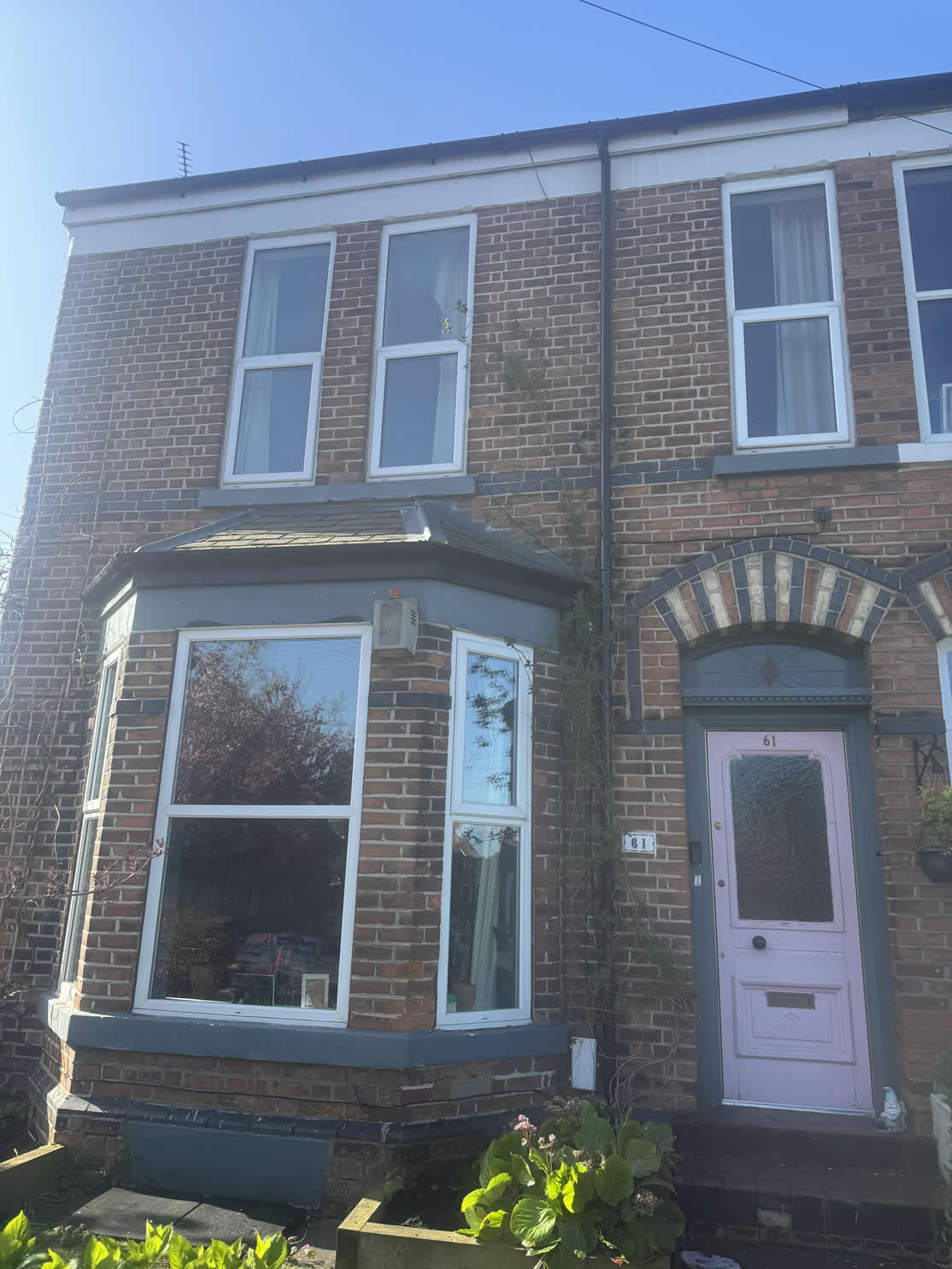 Front of Helen's home in Sale with white uPVC casement windows before replacement.