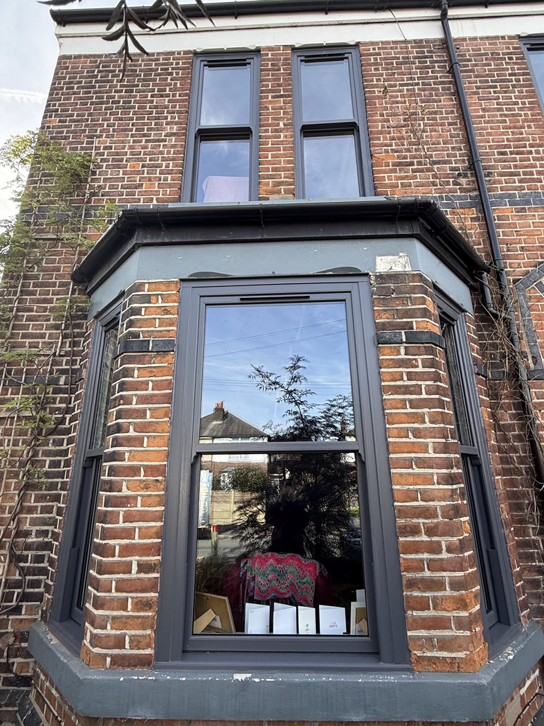 Close view of the Slate Grey sliding sash bay windows and upper windows at Helen's home in Sale.